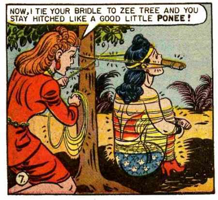 A panel from the old Wonder Woman comic. A woman is tying Diana to a tree saying "Now, I tie your bridle to zee tree and you stay hitched like a good little ponee!" The bridle is made of a piece of wood in Diana's mouth and golden rope. He body is tied into a sitting poison with arms wrapped around her legs, tucked into he body. It's very kinky.