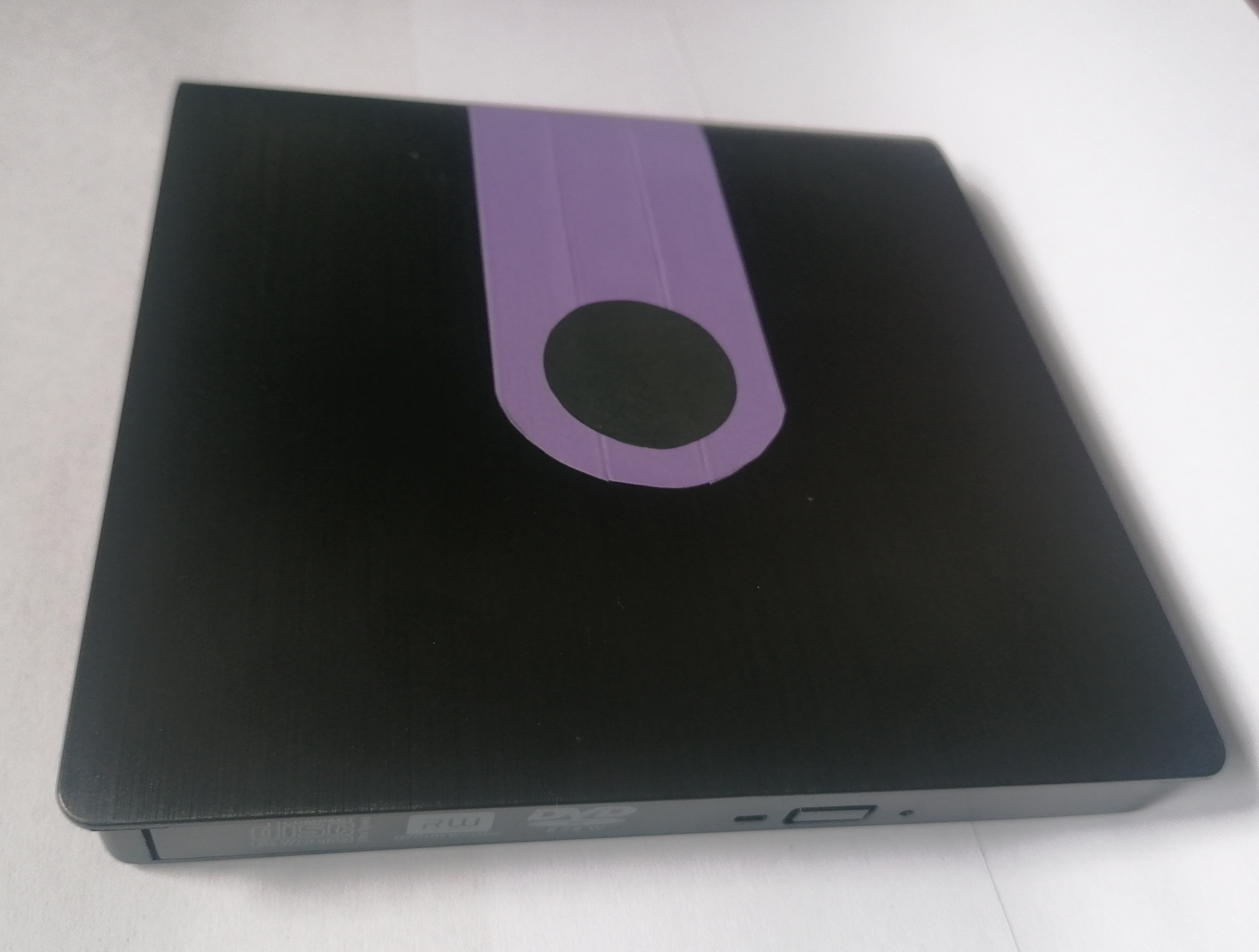 USB DVD drive with purple line on it.