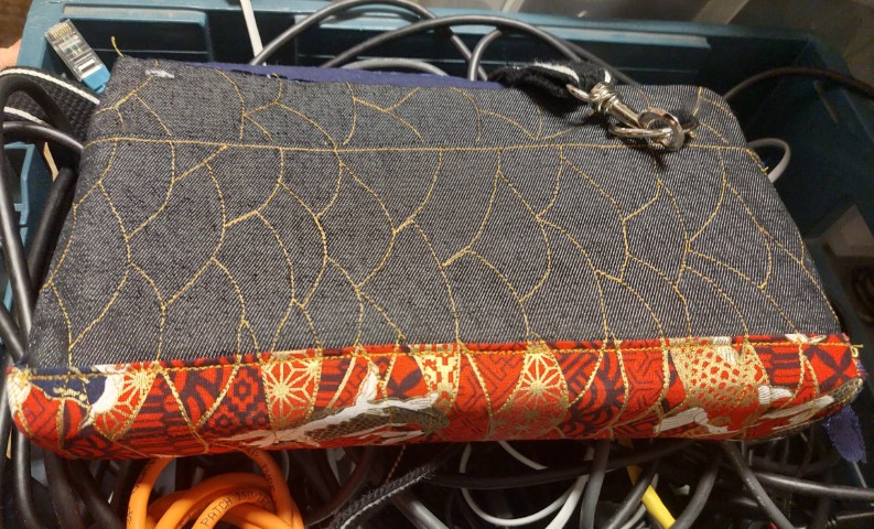 Side view of bag laying on a box of computer cables.